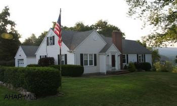 Charming Cape Cod overlooking the town of Everett; situated on 2.29 acres. Charming Cape Cod overlooking the town of Everett; situated on 2.29 acres. 2BR on main floor, 2 BR and bonus room upstairs, 2 full baths. Eat-in kitchen w/pantry; formal dining room w/ fireplace and built-in hutch; spacious living room with wood beams and shutters; built-in bookcase. Family room with kitchenette in basement. 1 car attached and 1 car integral garages. 1 car detached garage used as workshop with heat. Out building for storage. Spacious/  landscaped yard with flowers, brick sidewalk, large trees. Also oil back-up and generator.