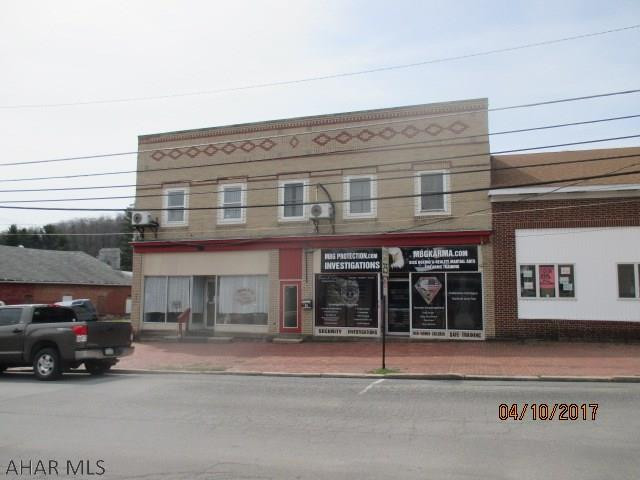 5 unit commercial and apt building. 1st floor consists of 2 commercial units currently rented as store fronts and garage unit.  2nd floor consists of 3 apartments.  The owner pays heat, water & sewage, and electric for common areas. Store fronts rent for $480/month, garage is rented for $50/month, and one apartment is rented at $425/month.  Two apartments are vacant but had been receiving $500/month each.