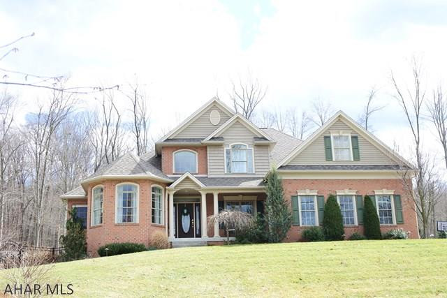 Stunning custom home situated on 4 beautiful acres...complete with heated salt water pool, pavilion and summer kitchen.  The home has abundant quality features from floor to ceiling...hardwood floors, vaulted ceiling in the Great Room, Mennonite made kitchen cabinets and stainless appliances.  The first floor is warm and inviting due in part to the double sided fireplace and the view of the Tussey Mountain waterfall in the backyard. Master Bedroom is spacious and has a tray ceiling and a sitting area...open the door to the patio and have the waterfall lull you to sleep.  Lower level is nicely finished with a bar area...living area with stone FP and a rec area, too.  Open the doors out to the inground, heated, saltwater pool..this area boasts a kitchen pavilon, perfect for Summer barbeques.
