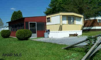 Front Enclosed porch/patio area. Nice 1981 Atlantic, 3 BR., Mobile Home - spacious screened in patio porch area.  Motivated Seller - hurry!!  Lot Rent is 178/mo.  W&S and Trash