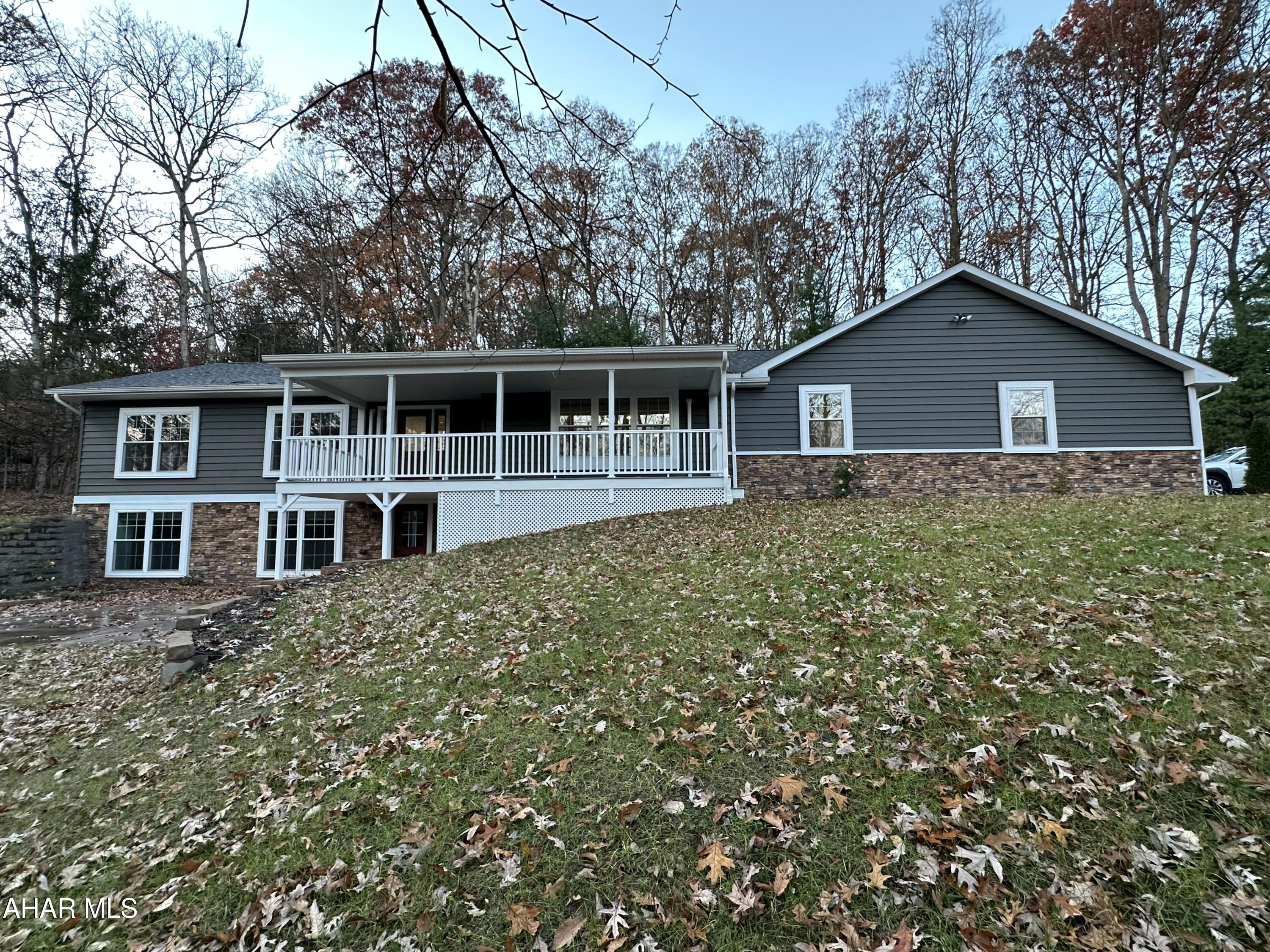 If you are looking for a home with quality you are definitely going to want to check out 10315 Tanglewood Drive, Huntington! This home is located in the beautiful Briarwood Development, convenient to Lake Raystown, on an acre of ground. The wooded lot provides lots of privacy. The home will require minimum maintenance with a new roof, CraneBoard vinyl siding and stone detail, composite decking and vinyl railing, the main living area is open with a sliding glass door opening directly to the covered back patio making this the perfect home for entertaining, the kitchen is completely custom with lots of cabinet space and the island top is quarter sawn white oak with epoxy, there are 3 bedrooms on the main floor and an additional bedroom in the fully finished basement that walks out to ground level to a concrete patio. there are three full bathrooms with tile tub surrounds and marble vanity tops, the laundry room is on the main floor, a bonus room on the main floor could be used for a home office or an additional bedroom. The home is energy efficient with R30 insulation in the walls and R50 insulation in the ceiling, and highly efficient Fujitsu mini splits, propane fireplace, the garage is oversized for two cars and storage for all of your tools and toys