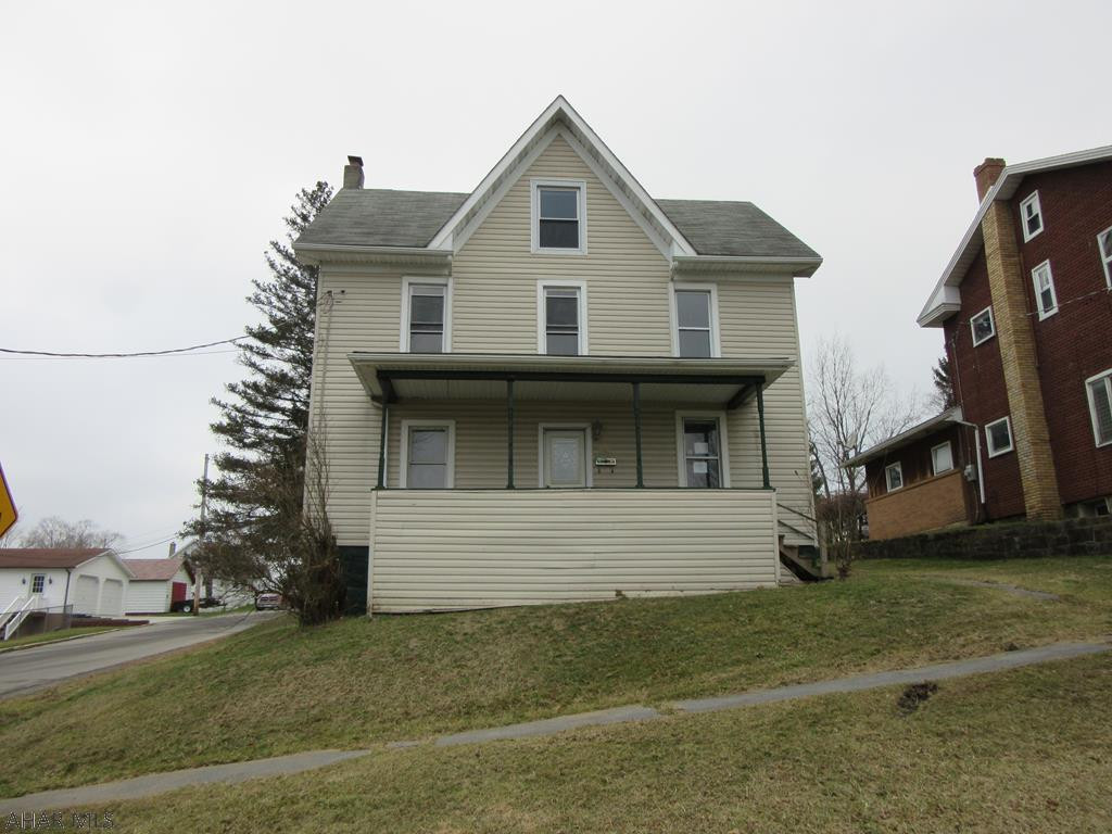 Lots of potential- spacious two story with oak kitchen and ceramic tile floors, two large full bathrooms, finished attic could be additional living area, two sheds
