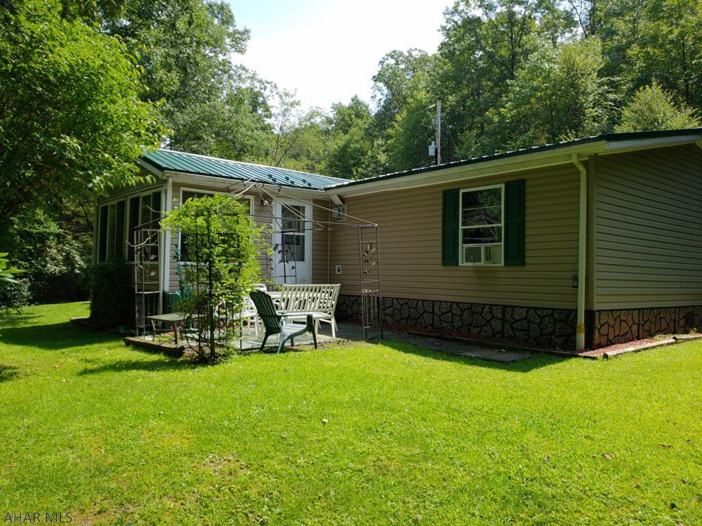 See 3D Tour coming soon! Situated on 31.02 acres of pristine land, you will find this well maintained, 3 bedroom, 2 bath home that has something to offer for everyone.  The cook will enjoy the well-appointed kitchen with new appliances which are included in the sale.  The hiker will find complete enjoyment after a hike through the woods.  Complete with 2 outbuildings, this property also includes a hobbyist building with pool table room and enough space to enjoy the projects you love.  The master bathroom features a garden tub, perfect for relaxing after a long day on the trails or in the office.  Features include a Randon reduction system, new sewer pump, new stovetop, new oven, security system, & house generator, This is in move in ready condition.  Finally, this property is Clean & Green