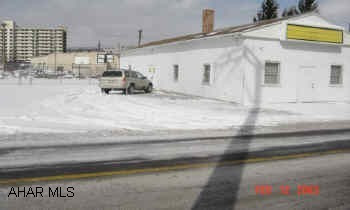 1 story 25x80' building with large parking lot and fenced area.  Zoned highway business.