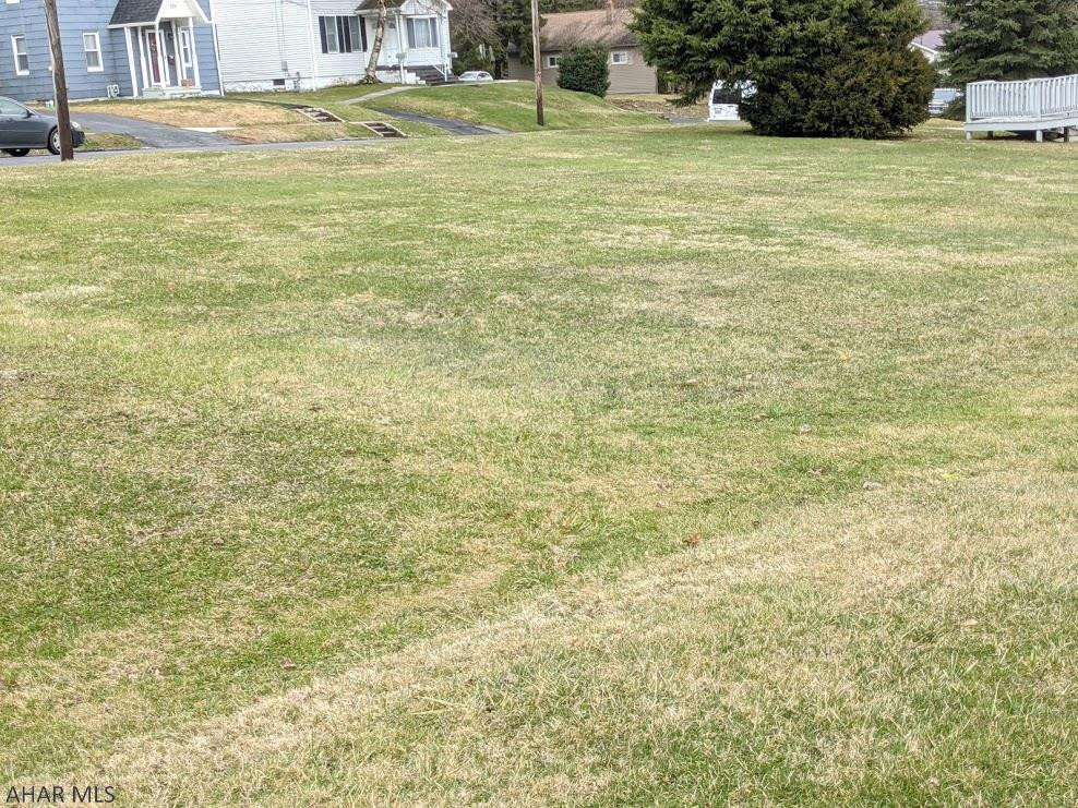 Level lot on East High Street; great location and within easy walking distance to town, walking trail, lake, and recreation! Public water and sewer available.  Lot has been surveyed and is indicated as Lot # 1 on Survey map. Home on the property is not included in the sale. Pictures include property and survey map. Zoned Multi-Household Residential.  Taxes are an estimate and will be adjusted accordingly when property sells.
