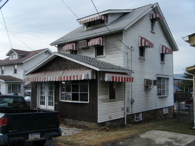 New carpet and padding. Nice sized living room with picture window. Large rear deck with roof. Garage roof is in poor condition. Property is zoned Highway Business.
