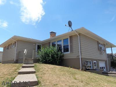 This attractive house has so much to offer!  Spacious fenced in yard on 4 city lots, hardwood & ceramic tile floors, 1 block away from a park, partially finished basement, fireplace, garage, updated electrical.  A great location and a great home for you!  8 years left on a transferable warranty from Terminix given to buyer.