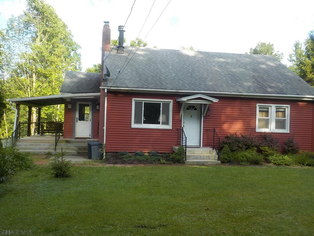 Great country setting!  4 bedrooms (2 on first floor), 1 bath.  Hardwood floors, updated kitchen & living room with a fireplace.  Wrap around driveway & the garage has storage above main level.