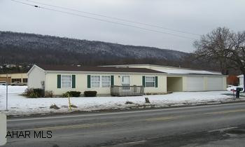 Like new 2000 Doublewide on cement block foundation, 3BR/2BA, central air, 2 car garage on easy care level lot with mountain view.