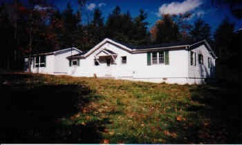 1 story with large family room, large 2 car garage, private 1 acre lot with stream and pond.  Electric not on.