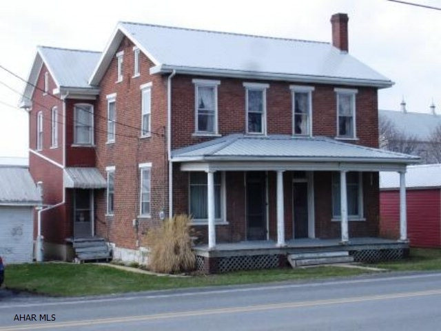 Large Brick Home with Great Character.  Recent Improvements Include a New Kitchen with Custom Cabinets, Addition with Half Bath and Laundry Room and a Beautifully Decorated Master Bedroom.  One Car Garage and Outbuilding Give Extra Storage Area.  Back Yard is Open and Level with Room for a Garden.  House Should Qualify for 100% USDA Financing.