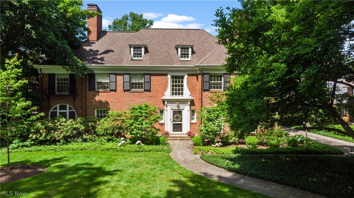 A striking center-hall brick Georgian on one of Shaker Heights' tree-lined streets. The grand foyer makes an immediate impression, drawing the eye to an elegant split staircase that sets the tone. French doors to one side open to the formal dining room; to the other, the living room flows to a screened porch, a refined office/library at the opposite end. Floor-to-ceiling windows in both the dining and living rooms flood the spaces with light and offer wonderful views of the outdoors.

Generously proportioned rooms are suited for grand entertaining and everyday life. The living room focal point is a stately, oversized fireplace, while the light-filled dining room is made for long dinners and good company. The kitchen is spacious— butcher block counters, an exposed brick wall, a Dutch door, and an adjoining scullery that connects seamlessly to the dining room. Just off the kitchen, a sunny breakfast room is the kind of space you'll find yourself in every morning.

The family room is where this home shines. Sprawling and beautifully appointed, it features a built-in beverage bar and multiple sets of French doors that open directly to the backyard — a manicured retreat with a patio, firepit, and privacy. A remodeled powder room and first-floor laundry round out the main level.

Upstairs, a light-filled reading nook anchors the second floor. Six to seven bedrooms and three full bathrooms offer plenty of flexibility. The oversized primary suite includes a dedicated dressing area. A private rear wing — reached via the back staircase — has two bedrooms, a sitting room, and a remodeled full bathroom, perfect as a guest, teen, or au pair suite. The finished third floor offers a spectacular, ballroom-scale room ready to be whatever you need it to be — gym, playroom, or something else entirely.

Attached two-car garage. Meticulously maintained and thoughtfully improved by its owners. The finished third floor offers an additional 750 square feet of living space.