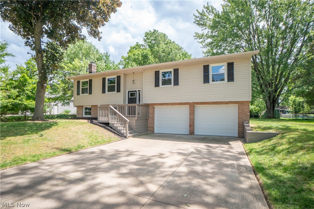 Completely updated and move-in ready, this beautiful bi-level home in Tallmadge offers modern finishes, comfortable living spaces, and a spacious setting on nearly half an acre. A charming front porch and new front door create a welcoming first impression before opening to a split-entry layout. Upstairs, the main level features an inviting open floor plan where the living room flows seamlessly into the eat-in kitchen, creating a bright and functional space for everyday living and entertaining. The kitchen has been tastefully updated with quartz countertops, a tile backsplash, stainless steel appliances, breakfast bar seating, and a sliding door that opens to the screened-in porch. From there, enjoy easy access to the outdoor deck overlooking the generous backyard, perfect for relaxing, grilling, or gathering with friends and family.

Down the hall, you’ll find three comfortable bedrooms, including a primary suite with its own newly remodeled private bathroom featuring a shower. An additional fully remodeled full bathroom serves the remaining bedrooms and main living area. The lower level adds even more finished living space with a cozy family room highlighted by a wood-burning fireplace, creating the perfect spot for movie nights or quiet evenings at home. A fourth bedroom offers flexibility for guests, a home office, or hobby space, while the unfinished utility area includes laundry hookups and a convenient half bathroom. Additional updates include new windows throughout, new baseboards in the living room, kitchen, and hallway, plus fresh modern finishes that make this home feel updated from top to bottom. Tucked in the cul-de-sac of the desirable Indian Park neighborhood, this home is close to local amenities like the baseball field and Maca Park with a pool!