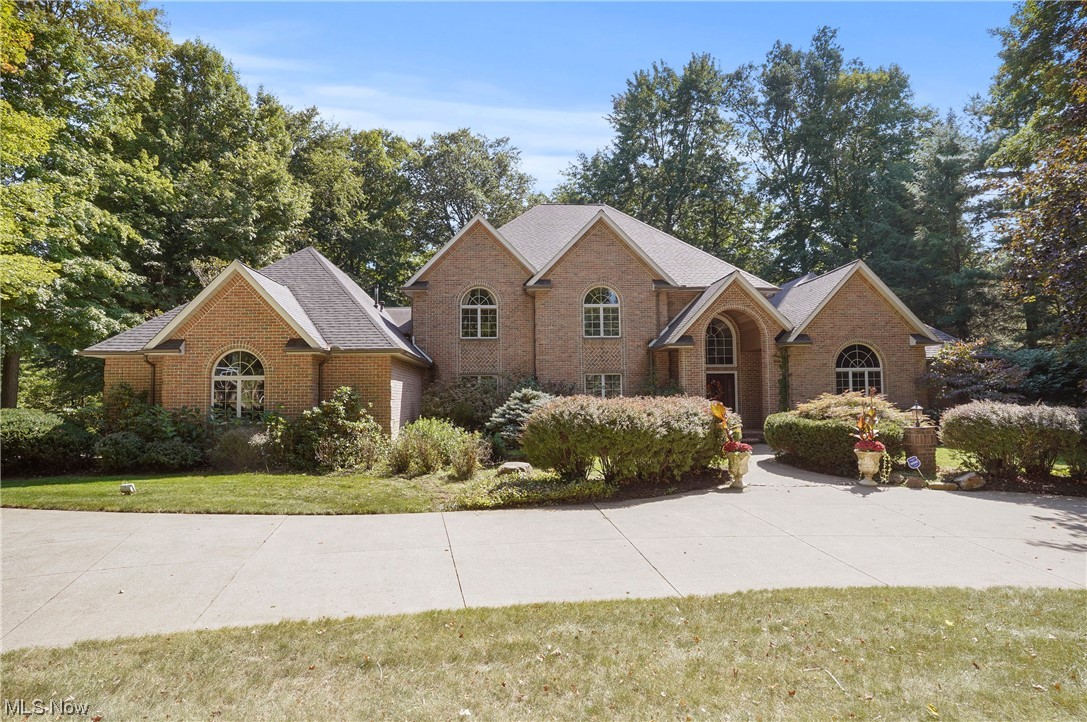 Spectacular Custom Build Brick Home in the sought-after Crystal Shores development in Bath Township!  This home features a Magnificent 1st floor Master Suite with Luxurious Bathroom W/entry to Deck/Hot Tub  & 2 walk-in closets.  3 additional Bedrooms on the 2nd floor, each with their own full baths.  Recently remodeled Kitchen and Master bath.  Rounded corners throughout the home enhance the beauty of the spacious hallways.  The lower level features include a full Bar, Theater Room, Family Room and Workout Room.  Plenty of storage space!  This home has a heated 4 Car Garage with an entrance to the lower level.  Enjoy the outside deck with a built-in grill and patio area with a firepit.