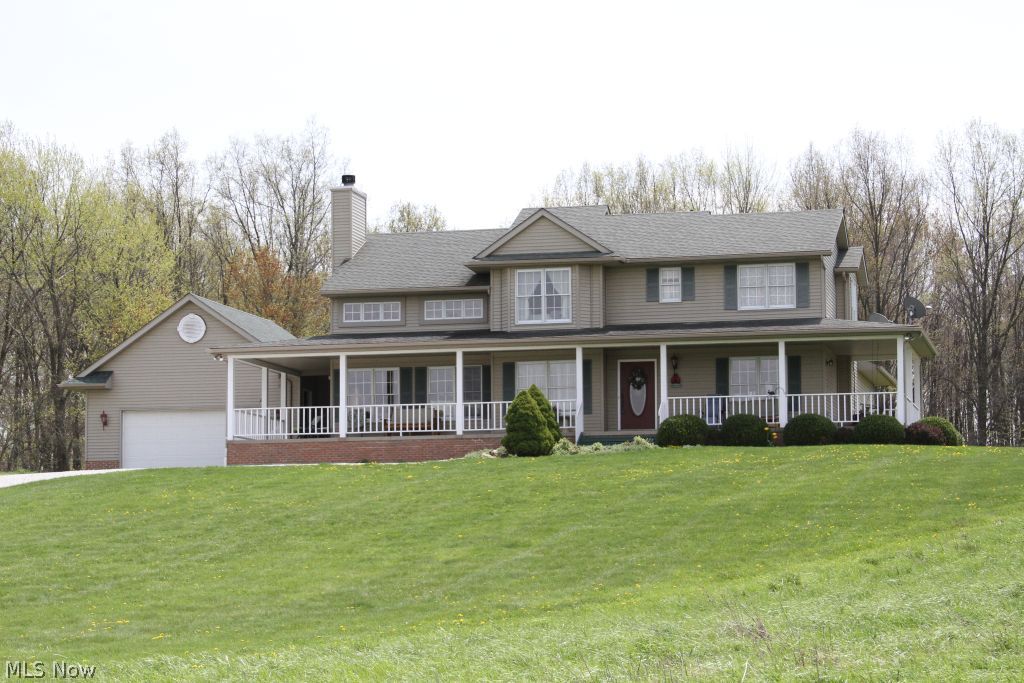 What a place to call home! A private lane leads to this beautiful custom built home on 13 acres. Lot consists of open fields, woods and a pond.  Free gas & royalties!  A peaceful private location yet close highway access.  Minutes to Canton, Hartville, Alliance. 4 bedrooms, 2.5 baths w/open spacious floor plan. 2 story great room & kitchen w/maple cabinetry. Dinette opens onto the rear deck. Wonderful 1st floor master suite, lie in bed & gaze at the stars through the skylight. Another first floor bedroom or office located on the main floor.  Second floor features 2 large bedrooms w/Jack & Jill bath. Lower level w/workshop/ built in tool bench.  A 28x30 barn provides space for 2 more cars, loft and more. Plus a pond for fishing! Updates include new gas water heater, new water well in 2012, dishwasher, built in microwave and roof.   Kick back and relax on the expansive wrap around porch and  enjoy the peaceful surroundings.  Call today for a showing.