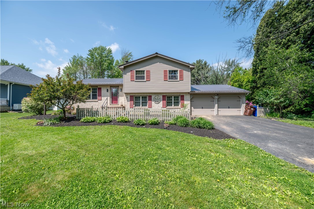 Beautiful split level on a quiet street in Poland.  3 bed, 2 ba, .69 acre, 1866 sf. 2 car garage. Huge family room, screened in sun room, new LVT flooring, newer items: metal roof 2017, gutter guards 2021, HVAC and HWT 2017, W/D and refrigerator 2019. This home is roomy inside and out.  The beautifully landscaped yard includes new mulch, a goldfish pond.  The backyard goes beyond the decorative fence.  It goes all the way back to the back neighbors shed/garage. Nothing to do but move in and make it yours.