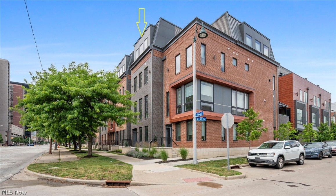 MOVE-IN READY and eligible for Cleveland's 15-Year Tax Abatement! Experience luxury urban living in the heart of Downtown Cleveland with Phase II of The Avenue Townhomes by Knez. Designed with contemporary style and exceptional craftsmanship, these stunning residences offer four levels of sophisticated living space paired with upscale finishes and breathtaking city views. This spacious townhome offers 2,497 square feet of thoughtfully designed living space, plus an additional 265-square-foot rooftop deck and an attached heated two-car garage. Three true bedrooms provide the flexibility and space you need, including a private first-floor en-suite ideal for guests. Soaring 10-foot ceilings on the main level and 9-foot ceilings throughout the rest of the home enhance the open, airy feel, while oversized Andersen black windows flood the interior with natural light. An electric fireplace adds warmth and style to the living area. The beautifully appointed kitchen is designed to impress, featuring a large quartz island, KitchenAid stainless steel appliances including a vented chimney hood, microwave drawer, and dishwasher, along with 42-inch soft-close cabinetry. Premium finishes continue throughout with luxury vinyl flooring, designer tile, plush carpeting, and quartz countertops on every level. Retreat to the luxurious primary suite featuring dual vanities and an exquisite tiled shower with a frameless glass door. The fourth floor is made for entertaining, complete with a recreation room, wet bar, half bath, and direct access to the private rooftop deck where you can enjoy spectacular and ever-changing Downtown Cleveland views. Built with efficiency in mind, this home features a 95% efficient York furnace, 13 SEER York air conditioner, and a Rinnai tankless water heater, providing energy savings and modern convenience. Combining upscale finishes, versatile living spaces, and an unbeatable Downtown location, The Avenue Townhomes deliver a truly elevated lifestyle.