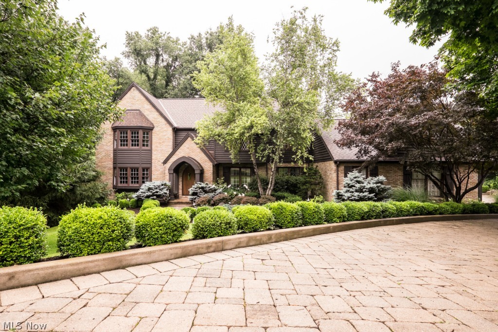 This amazing Custom built, one owner home in Hills and Dales Village is nestled on a 2.4 Acre private and wooded lot. Quality of construction and attention to detail are evident from the all brick and cedar exterior, cobblestone driveway, cathedral style wood surround entranceway, spacious rooms, amazing Schrock Cherry kitchen and the Year round In Door 30x60 Pool. The functional floor plan flows perfectly with a space for family and friends alike. Enjoying your morning coffee/tea in your bright Breakfast room overlooking the manicured back lawn or on your private multi-level cedar deck. The fully applianced Kitchen boasts ample counter space, built in pantry, Insta Hot, vegetable sink, double ovens, built-in desk and indoor grill. The Master Retreat has a wonderful lounge and reading area and the Master Bath boasts marble surround shower, custom closets w/ shoe and tie racks, dressing area and cedar closet. Recent upgrades to the home include New Roof 2014, Garage openers 2015, A/C 2013, carpet and paint. Total Square footage includes the finished Lower Level and In Door Pool area.
