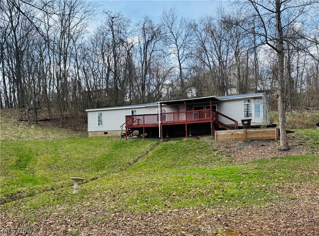 Set on 1.33 wooded acres in the Belpre School District, this property offers space, scenery, and plenty of potential. Tucked into a semi-private setting with outstanding views. This 5 bedroom, 2 bath double wide with addition sits on a permanent foundation and offers a great opportunity for a buyer ready to make a few updates and add their own personal touch. The spacious layout includes an open main living area and plenty of room both inside and out to create the lifestyle you want. Minor repairs such as flooring and drywall work will go a long way in bringing this property back to life. With room for a garden, garage, outdoor entertaining space, or simply enjoying the peaceful surroundings from the covered porch and front sun deck, this property is full of possibilities. HUD Case #413-769692. Sold in as-is condition.
