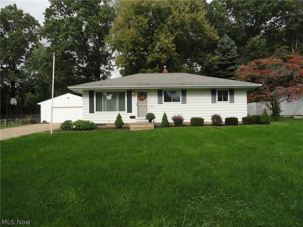 Here's a sharp ranch in a desirable Munroe Falls neighborhood situated on an extra wide lot. Pristine and very well maintained by same owner for many years . 
Impressive curb appeal, deep lot with mature trees and professionally landscaped, concrete driveway, two car garage. Bright and open floor plan, cheery vintage kitchen! Spacious rec room plus office in lower level. New windows in '17, HVAC '14, hardwood floors under that updated carpet. Move in ready! Home Warranty included.
