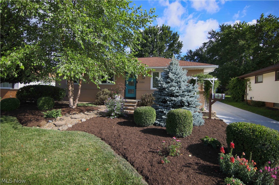 Welcome home to this beautiful 3 bedroom 1.5 bathroom ranch.  As you enter into the front door you are welcomed into the open living room with a cozy fireplace.  The living room opens up into the dining room with glass sliding doors leading to the backyard.  Attached to the dining room is a beautiful kitchen with an island. The hallway will lead you to a full bathroom and 3 spacious bedrooms.  Pass through the kitchen to the half bathroom and large sun room which leads to the backyard. Partially finished lower level you will find a recreation room, large laundry room, a workshop area, and a bonus room! Large detached 2 Car Garage. New Concrete Driveway 2021, New Gutters on house 2021, New Front Door 2022.