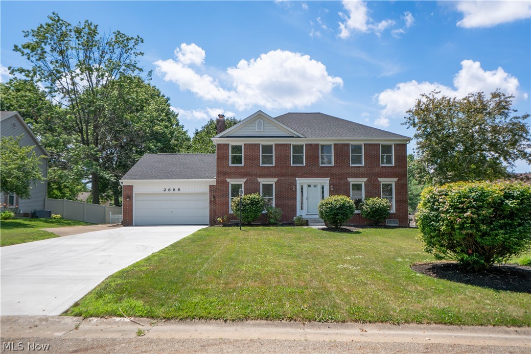 Completely updated and beautifully finished, this spacious St. Ives Colonial offers 4 bedrooms, 3 full bathrooms, over 3,400 square feet of finished living space, and a desirable North Canton location. A welcoming foyer greets you with a large coat closet, wide staircase, and new flooring that continues through the entire home. Double doors open to the living room, which flows seamlessly into the formal dining room, creating a bright and inviting layout for everyday living or entertaining. The eat-in kitchen features stainless steel appliances, granite countertops, ample cabinetry, a coffee bar, and breakfast bar seating. The dinette area includes sliding doors to the back deck, while the family room just off the kitchen offers a cozy gas fireplace and another slider to the covered deck. Pocket doors open to a private den or office with a floor-to-ceiling built-in bookshelf wall. A first-floor laundry room and full bath with standing shower and tile surround complete the main level. Upstairs are four generously sized bedrooms with large closets, including the primary suite with a walk-in closet and private bath featuring a dual-sink vanity, soaking tub, and tiled shower. The additional full bath offers a dual-sink vanity, skylight, and tiled shower, plus a large walk-in hallway closet for extra storage. The finished lower level adds a large recreation room and two bonus/flex rooms, perfect for a media room, playroom, fitness area, or hobby space. The unfinished utility area includes two hot water tanks, a utility sink, crawlspace access, and additional storage. Outside, enjoy the partial covered two-tier deck with attached ramp overlooking the spacious fenced backyard. Updates include a new roof in 2026, new flooring, fresh paint, updated bathrooms, new electric outlets, new concrete driveway and walkway, plus side parking for an extra vehicle. This move-in-ready home offers space, updates, storage, and a wonderful neighborhood setting!