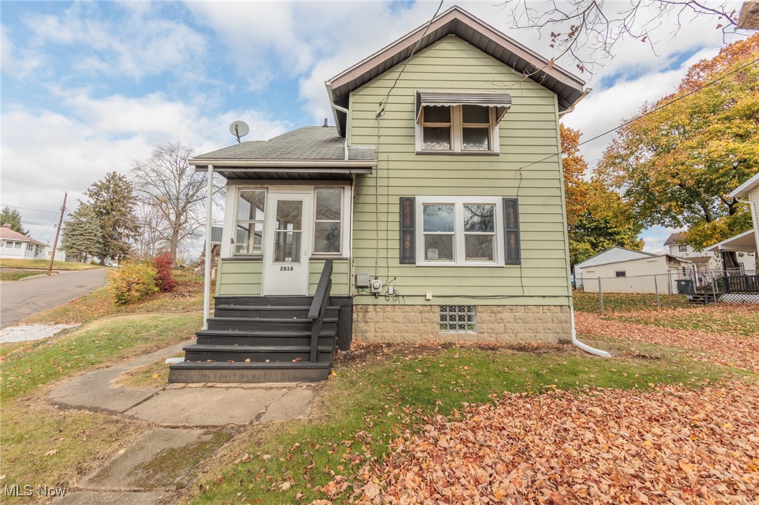 This charming, fully updated colonial-style home in Akron offers so much character. This darling home features two spacious bedrooms and two full baths. Step inside to find a bright, open floor plan featuring freshly painted walls, stylish fixtures, and beautiful flooring throughout. The living room has a large front window to allow natural light to shine in. The living room flows seamlessly into the dining room, which would allow for the perfect entertaining space. The kitchen has been fully modernized with stainless steel appliances, and white shaker cabinets. Upstairs, two generously sized bedrooms offer abundant natural light, closet space, and a tastefully renovated bathroom with contemporary finishes. The basement is partially finished with a full bathroom, perfect for an office space or entertaining room. Outside a cozy front three season room allows you to enjoy the landscaped yard through the seasons. Located in a quiet, well-established neighborhood, this home combines timeless colonial charm with all the updates you need for modern living.