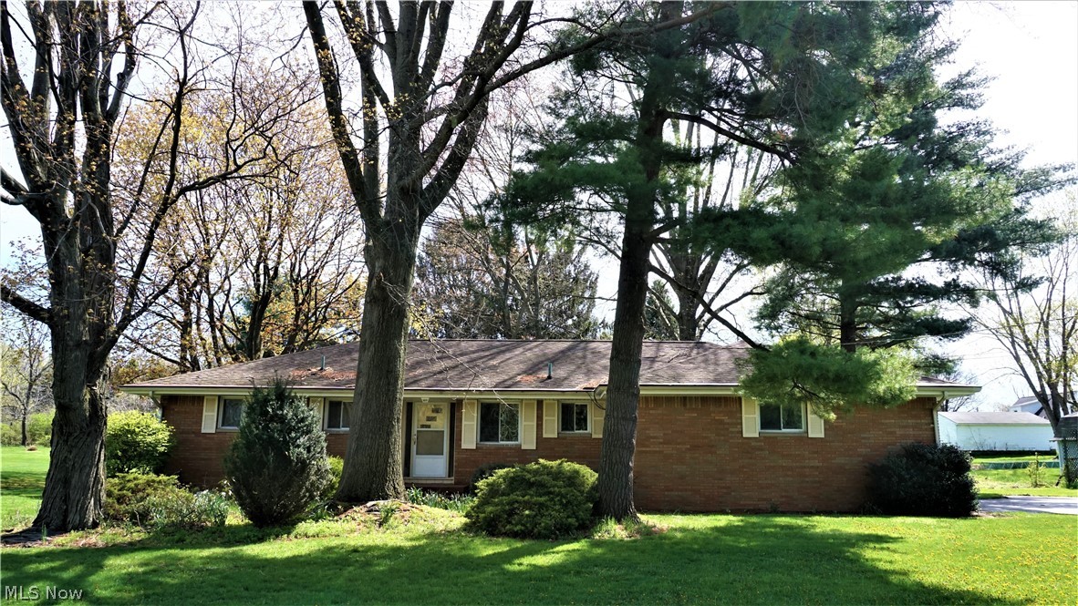 Excellent opportunity in the Lake School District! Brick ranch conveniently located near schools, shopping and highways in a quiet neighborhood in Uniontown. Large eat-in kitchen with newer Range and Dishwasher, laminate counters and tile backsplash. Spacious Family Room includes views of the backyard through a sizable picture window, wood burning fireplace with stone surround and concrete hearth, built-in shelving and ceiling fan. 3-seasons room encased with wall of windows has access to a wooden deck and pergola in the backyard. 2 oversized bedrooms both have loads of closet space and hardwood floors. Full bath with single vanity, oversized counter, attractively tiled walls and ceramic tile flooring. Partially finished basement sports 2 living areas. Large carpeted recreation room with brick fireplace, built-in shelves, and multiple glass block windows providing plenty of natural light. Second living space can serve as an office or a 3rd bedroom which is supported by the 2nd full bat