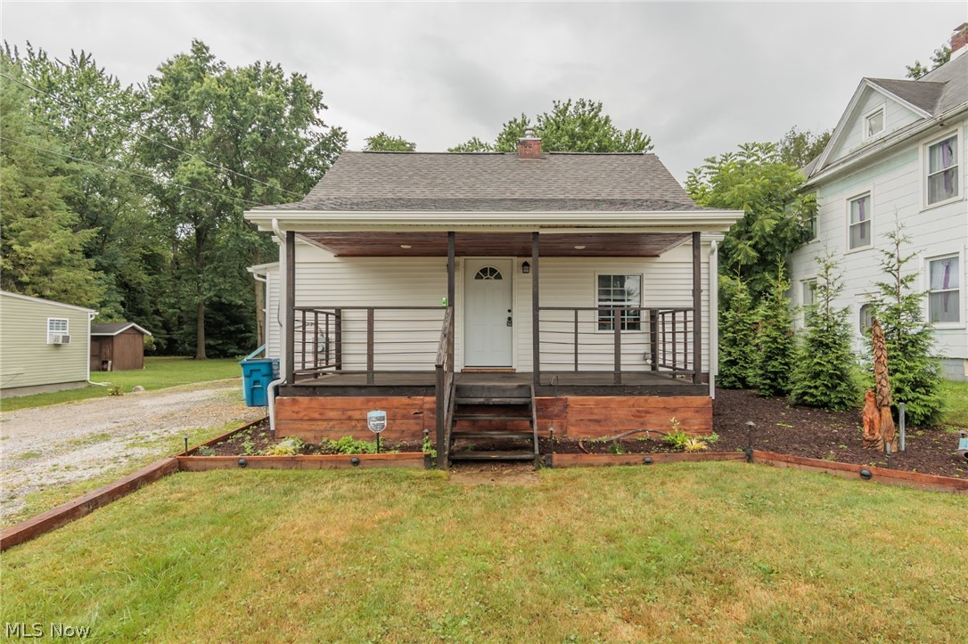 A charming Hartville bungalow with a dream back yard.  This lovely home features a custom kitchen with quarter sawn white oak countertop, shaker style soft close cabinets, a whitehaus sink, and wonderful ceramic floor.  The oversized bathroom with blow you away.  Of then many characteristics of this home, the stairs are a live edge cherry, with a handrail made of finger joined black walnut, which is also a few of the doors.  The open living room has a built in entertainment center made of ambrosia maple wrapped in tongue and groove knotty pine.  There is a front porch is made of 2" eastern red cedar, as are the Pavilion and Pergola.  The yard is completely fenced.  A full basement, garage, and so much more.