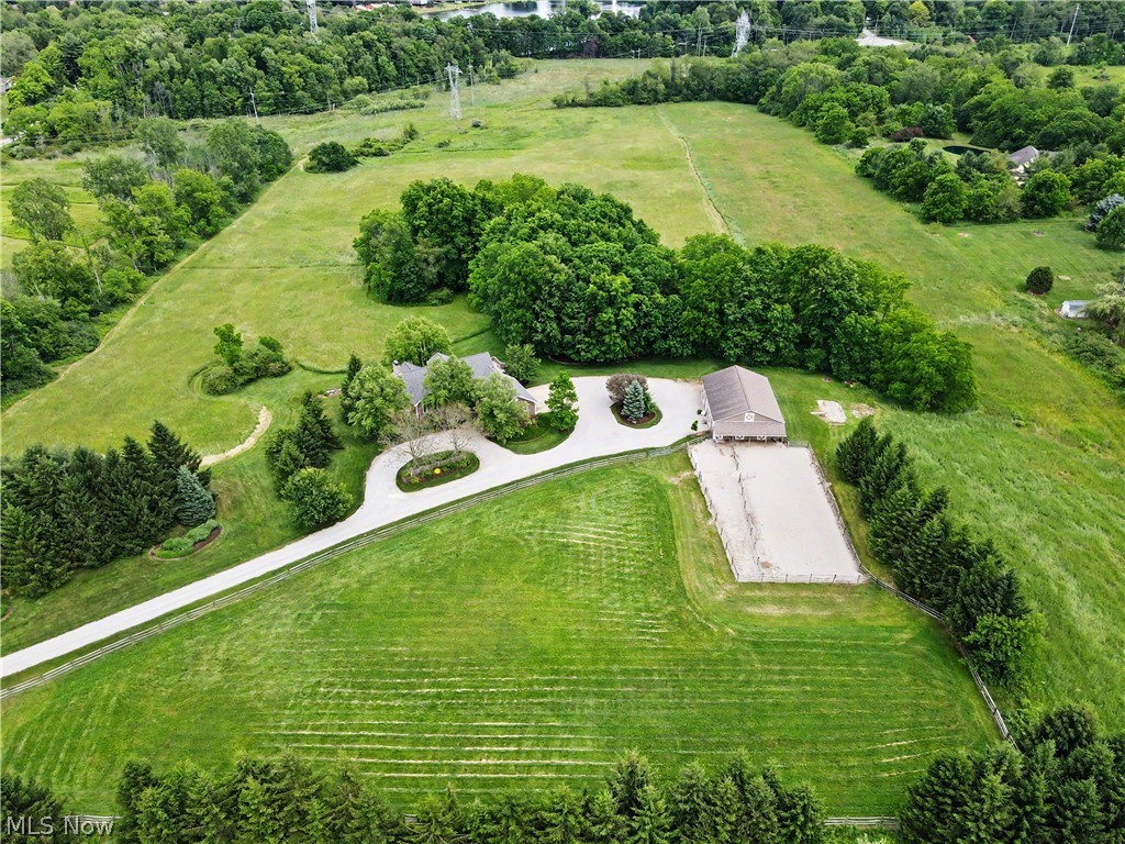 Nestled on 17 scenic acres in Granger Township, this custom built Boggs Cape Cod offers the perfect blend of privacy, quality craftsmanship, and country living. Surrounded by mature trees, open pasture, and a picturesque creek, the property provides a peaceful retreat with convenient access to Hinckley Metro Parks, the Bath Pony Club, shopping, dining, and major highways.
Offering over 3,100 square feet of finished living space, the home features a desirable first floor primary suite with private balcony access overlooking the property. The updated kitchen features granite countertops and opens to inviting living spaces highlighted by a fireplace and beautiful views of the surrounding landscape. An enclosed covered porch extends the living space outdoors, creating the perfect place to relax and enjoy the tranquil setting.
The finished walkout lower level adds flexibility with a family room, kitchenette, recreation area, two bedrooms, and direct outdoor access, making it ideal for guests and entertaining.
Outside, the possibilities are endless. The Amish built 36 x 48 barn features three stalls, a heated tack room with hot water, workshop space, automatic waterers, all weather paddocks, and approximately four acres of pasture. An outdoor riding arena, screened porch, equipment storage area, and expansive open space further enhance the property's versatility for recreation, hobbies, animals, or simply enjoying the acreage.
Numerous updates provide peace of mind, including a brand new roof, furnace and air conditioning, Anderson windows and patio door, newer hot water tank, updated appliances, security system, and gutter guards. A heated three car attached garage and quality 2x6 construction further reflect the care and investment made throughout the property.
A rare opportunity to own a beautifully maintained home with exceptional amenities on over 17 acres in one of Medina County's most desirable locations.