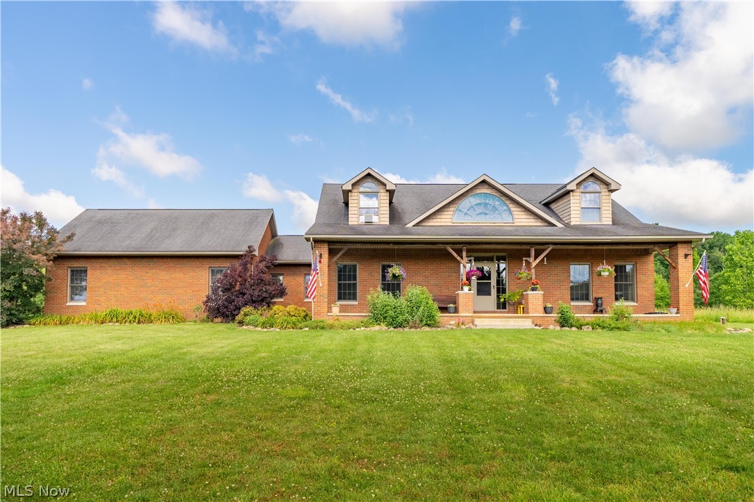 Nestled on 13.11 scenic acres in Marlington Local School District, this exceptional home offers over 3,100 square feet of thoughtfully designed living space. A long private driveway welcomes you home, offering beautiful countryside views before you even step inside. From the moment you enter the sun-filled foyer, you'll appreciate the gleaming hardwood floors and abundance of natural light. To the left, a dining room provides the perfect space for family gatherings, while the office to the right features direct access to the primary suite, making it an ideal nursery, 4th bedroom, or a first floor in-law suite. The two-story great room serves as the heart of the home, with vaulted ceilings, and a floor-to-ceiling stone fireplace. It flows into the eat-in kitchen, complete stainless steel appliances, an island, and a bright dining area with sliding doors leading to the backyard patio. Step outside and enjoy peaceful views of this expansive property. The patio offers the perfect place relax with your morning coffee, or simply take in the beauty of your surroundings. The first-floor primary suite is a retreat, featuring two walk-in closets and a luxurious ensuite bath with dual vanities, a soaking tub, and a tiled shower. A convenient laundry room and half bath complete the main level. Upstairs, you'll find two generously sized bedrooms, each with charming window nooks, along with a full bathroom. The unfinished walk-up basement offers room for storage and access to the attached two-car garage. Adding even more value, the impressive detached garage is large enough to accommodate an RV and is equipped with water, electricity, and an attached carport, perfect for outdoor enthusiasts, or anyone needing extra workspace. If you've been searching for privacy, acreage, and a home that offers both comfort and functionality, this is one you won't want to miss. Schedule your private showing today! Missing window trim has been ordered and will be installed prior to closing.
