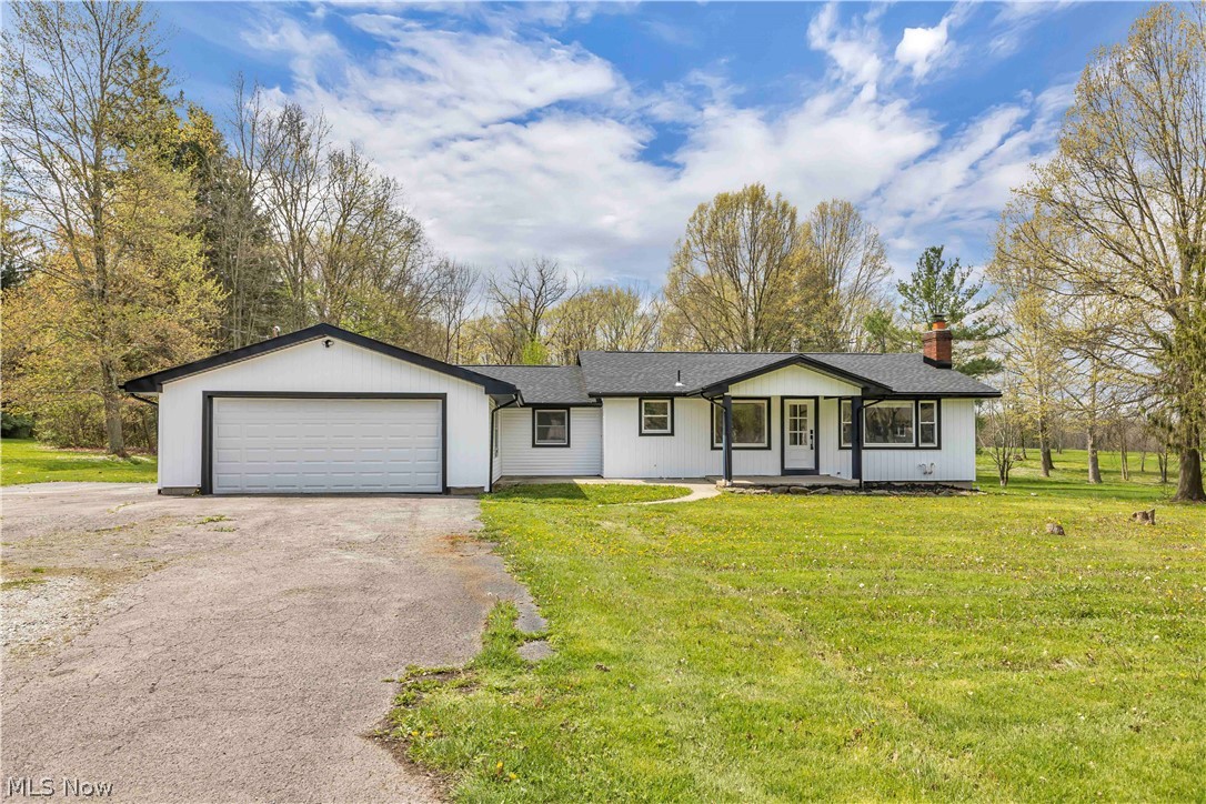 Welcome to this exceptional ranch on 1.2 scenic acres in highly sought after Canfield Schools offers a rare combination of modern updates, peaceful surroundings, and everyday functionality. Featuring 3 bedrooms and 2 full baths, this beautifully reimagined home welcomes you with an open, light filled layout designed for comfortable living and effortless entertaining. Inside, you’ll find luxury flooring, updated lighting, fresh finishes, and spacious living areas highlighted by a stunning fireplace that serves as a warm focal point to the main gathering space. The thoughtfully updated kitchen features stylish cabinetry, modern finishes, ample prep space, and a layout that opens seamlessly to the main living and dining areas, creating an inviting flow throughout the home. Both full baths have been tastefully renovated, and the generously sized bedrooms provide comfortable retreats. Extensive updates throughout offer true move in ready living, including a new roof for added peace of mind. Step outside and enjoy the impressive covered patio, perfect for morning coffee, outdoor dining, or entertaining while overlooking the beautiful 1.2 acre setting. The expansive yard offers endless possibilities for recreation, gardening, or simply enjoying the privacy and tranquility of the property. Surrounded by mature trees and open green space, the setting provides a peaceful country feel while remaining conveniently close to shopping, dining, parks, and major routes. With beautifully updated interiors, spacious living areas, desirable outdoor amenities, and a sought after Canfield Schools location, this property offers the best of both comfort and lifestyle. Rarely does a fully renovated home with acreage, privacy, and modern appeal come available in such a prime location. A truly special opportunity to enjoy turnkey living in one of the area’s most desirable settings. Don't miss this amazing opportunity and schedule your private showing today!