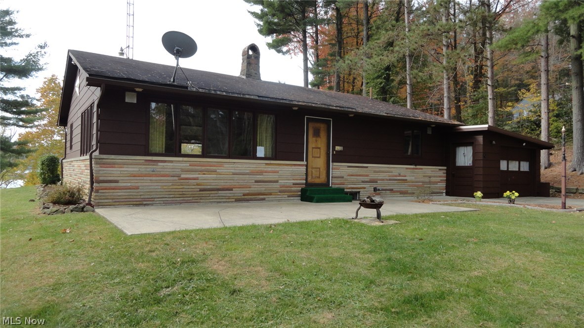 Enjoy beautiful views of Tappan Lake from this lakefront home!  2 bedroom, 2 bath stone and wood frame ranch.  Stone wood burning fireplace in the family room.  Sliding glass doors in the kitchen lead to the patio.  Newly painted interior.  New flooring coverings throughout.  Thermo pane windows.  Freshly painted exterior-2015.  120 gallon electric hot water heater.  20 X 7 attached workshop.  37 X 13, 2 car attached garage.  The taxes reflect the seller receiving a homestead credit of $399.92 annually.  Includes the dock currently on the bank.  Exclude the air compressor.  Annual MWCD lease fee of $2,387.00 for 2015.