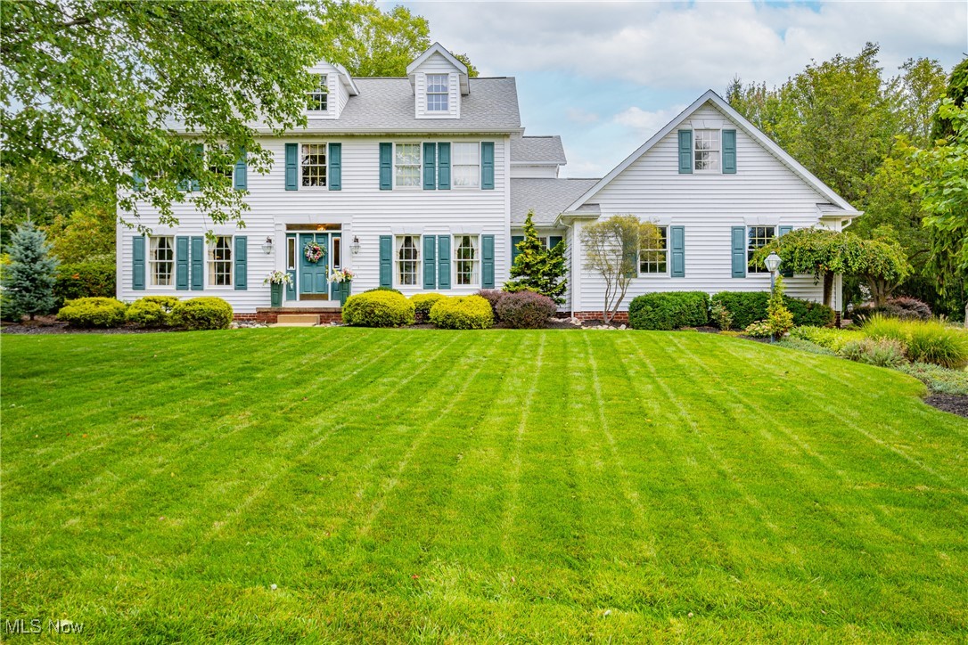Back on the market! Priced to sell with a refreshed main bedroom and bathroom. There are still some gorgeous autumn days left to enjoy the hardscaped backyard and gas fire pit. Roof, siding, downspouts/gutters - all replaced in 2020.

This 4 bedroom, 2.5 bath custom colonial home was one of the first built in the Mayfair Lakes development, filled to the brim with quality finishes, and lovingly cared-for by one owner. The interior design gives a classic, coastal-cool feeling that invites you from the main entry and sitting room, through the glass French doors, and into the spacious living room to take a seat by the fireplace.

White-washed oak cabinets and cream tile floors continue the airy flow into the kitchen, complete with eat-in area, kitchen island, and included stainless steel and black appliances. The first floor laundry, quiet den with wood flooring, half bath and 2+ car garage round out the main floor of this spectacular home.

Following the real grass cloth covered walls up the stairs to the second level, you’ll find 4 generously sized bedrooms. The primary bedroom, complete with ensuite bathroom and walk-in closet, draws your eyes up toward the vaulted ceiling. The 3 remaining bedrooms and full bathroom on this level are sure to provide plenty of space and storage areas. The HVAC system includes a high efficiency furnace and AC, installed in 2016.

The final “piece de resistance” is the show-stopping hardscape patio overlooking a fountain and pond. Ninety-three authentic Wooster barn stones make up the 3 tiers of seating areas, gas fire pit, natural waterfall and outdoor kitchen with a sandstone top. A top-of-the-line Coyote grill and side fridge will allow you to spend more time with your guests in the great outdoors.