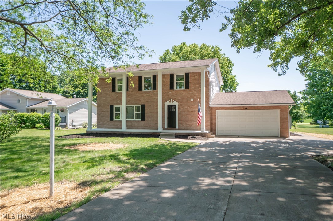 Beautifully updated Colonial in Hidden Knolls Estates offering fresh style, functional space, and a wonderful indoor-outdoor flow. A stately covered front porch with two-story pillars welcomes you inside, where the entry opens to a bright living room filled with natural light from large front windows. The living room continues seamlessly into the dining area and eat-in kitchen, featuring quartz countertops, stainless steel appliances, pendant lighting, a breakfast bar, and crisp modern finishes. Just off the kitchen, the comfortable family room offers a cozy fireplace and sliding doors leading to the enclosed three-season sunroom with a skylight, creating the perfect spot to relax while overlooking the backyard. A newly updated half bath completes the main level.

Upstairs, you’ll find four bedrooms, including a spacious primary suite with a walk-in closet and beautifully remodeled private bath with a tiled walk-in shower. Three additional bedrooms share an updated full bath, and the convenient second-floor laundry closet adds everyday ease. The lower level provides even more living space with a finished recreation room, plus an unfinished area ideal for storage, utilities, or future possibilities. Outside, enjoy the concrete patio, spacious yard, storage shed, attached 2-car heated garage, and additional driveway parking. With updated finishes, generous living areas, and a desirable Lake Township location, this home is ready to impress!