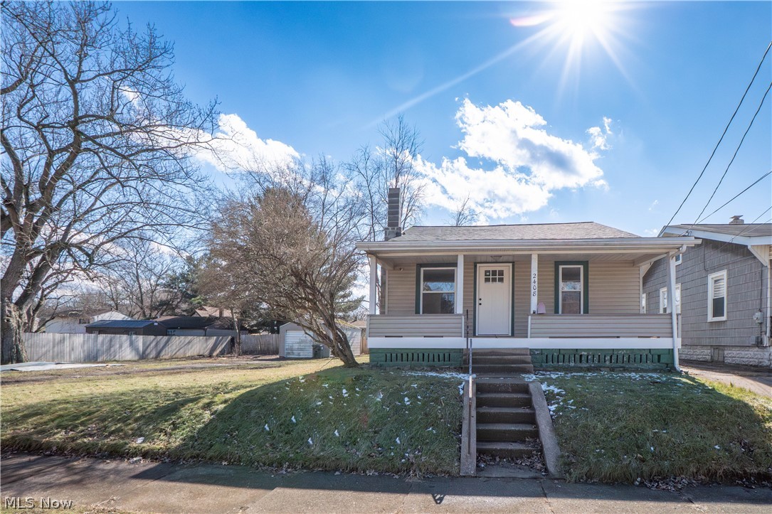 Move right into this beautifully updated bungalow offering fresh finishes and thoughtful improvements throughout! A spacious covered front porch sets the tone and provides the perfect spot to relax. Inside, you’ll find an open living room with new LVT flooring that flows seamlessly into the dining area, creating a warm and inviting space for everyday living and entertaining. The remodeled kitchen features painted cabinetry, a new countertop, new faucet, and new stainless steel stove/oven, plus convenient walk-out access to the backyard and built-in storage for added functionality. The fully renovated main bathroom showcases a brand-new shower/tub combo and updated fixtures for a clean, modern feel. The main level offers a generously sized bedroom along with a flexible bonus room—ideal for a home office, nursery, or expanded closet space. Upstairs, the charming loft-style second bedroom provides cozy privacy and ample room. Fresh paint, new baseboards, updated lighting, new interior and exterior doors, a new roof, and new flooring throughout give this home a crisp, move-in ready appeal. Additional highlights include an unfinished basement with laundry hookups, new basement windows, central air, and a detached one-car garage situated on a spacious double lot—offering plenty of room to enjoy the outdoors. Whether you’re looking for your first home or a solid investment opportunity, this updated and affordable property is ready for its next owner!