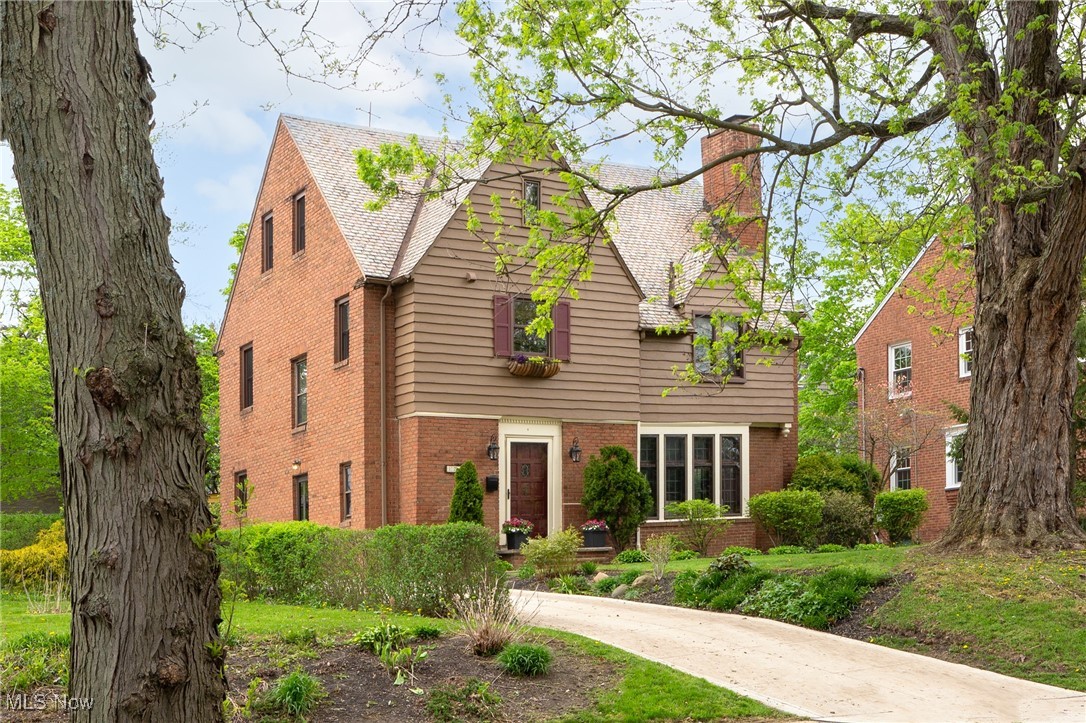 Step inside to see the sunlight dancing through leaded-glass windows, casting a glow on rich woodwork all around. Beyond each original 8-panel door, there is another detail to make you smile — from the original tile in the foyer, to the wrought iron railing, antique chandelier, and glass front butler’s pantry. So far, the classic Tudor details have captivated you. Now, you will find an inviting Colonial twist as the kitchen flows into the expansive yet cozy family room and its sliding glass doors to the beautiful stone patio. Gaze at the stars or the original slate roof which still crowns the home is all its glory with timeless style. Back inside, imagine life unfolding as you explore nearly 3,100 square feet of finished space across four levels. Location? Perfectly positioned so you can choose Fernway (zoned) or Lomond (another option) as your elementary school; and, just moments from parks, libraries, and the buzz of the Van Aken District. Homes with this much character, charm and space don’t come along every day. Come see it — and feel it — for yourself before it’s gone!