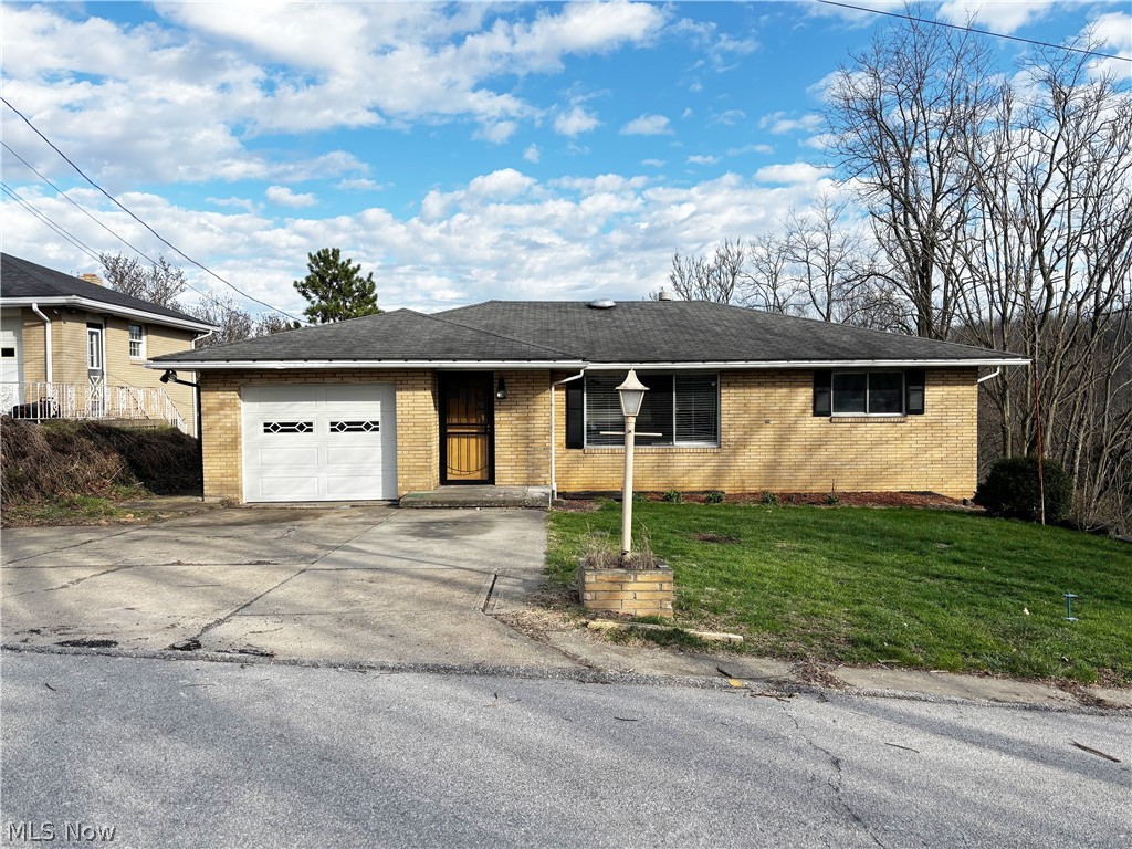Welcome to this well-situated 3 bedroom, 2 full bathroom home in the heart of Weirton, WV, offering a thoughtful blend of living space, convenience, and entertaining potential. This brick ranch-style residence features an inviting eat-in dining room with an attached deck, ideal for outdoor gatherings and everyday enjoyment. The attached 1-car garage includes attic access via pull-down stairs, adding practical storage options. New hot water tank installed in 2026. The lower level boasts a large recreation room with a built-in bar, an additional versatile room, and a dedicated laundry area, all anchored by walk-out basement access — perfect for indoor/outdoor flow and future customization. With approximately 1,260 sq ft of living space, this residence provides functional living areas and the opportunity to tailor updates to your taste. Located in the established 26062 ZIP code of Weirton, this home enjoys proximity to shopping, dining, parks, schools, and major commuting routes. Don’t miss your chance to own a home with character, functional space, and the potential to make it your own.