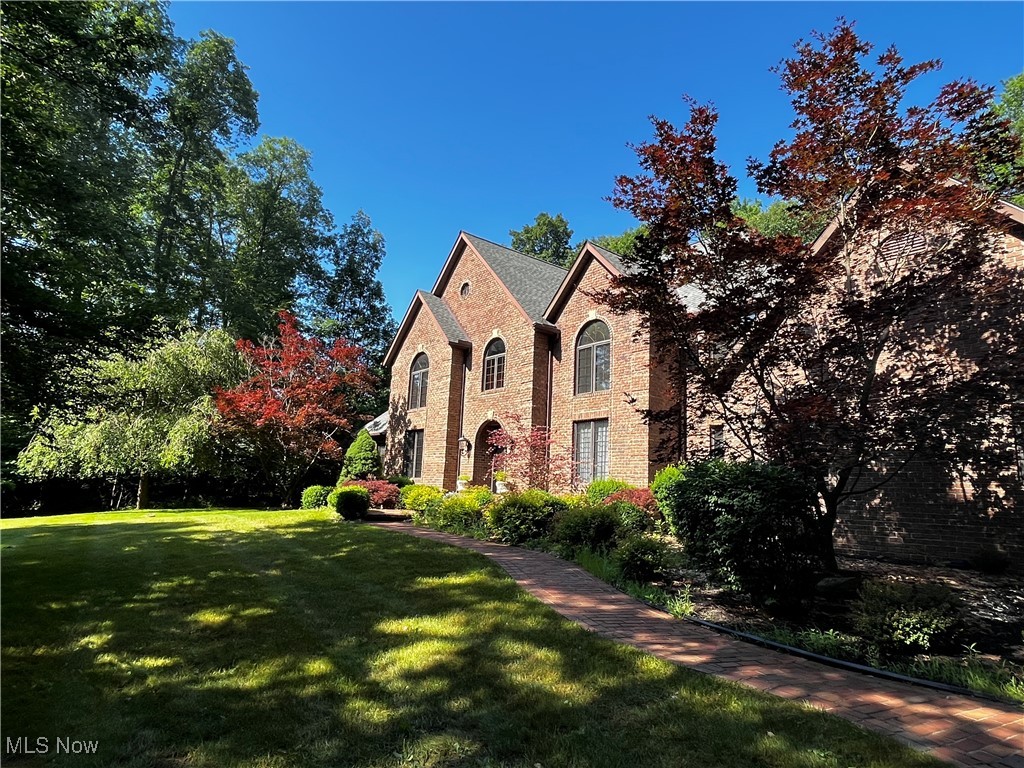 Custom built brick Colonial on a 3.5 acre lot (Richfield Township ) including private enclosed pasture and 2,400 Sq. Ft. Horse Barn. This lot has been tastefully developed for privacy.  Bring your own horses or lease the barn for this popular recreation in the heart of Richfield. This property also included an active natural gas well serving the home.  Walking up and into this traditionally built custom home, you can appreciate and respect the elegant two story foyer with open natural wood stairway and natural light and marble flooring. The foyer opens into the stunning two story great room with hardwood floors, marble hearth fireplace, a view of the private yard, and a second open natural wood stairway.  The great room is accented with rich natural wood paneling, traditional natural wood trim and crown molding. The gourmet kitchen is of open design, has rich dark wood cabinets, complimenting granite counter tops, providing warmth to this family area.   A breakfast bar with cooktop, built in double oven, pantry and dinette area with French doors to the private brick patio.  There is a formal dining room, powder room, laundry room, living room, and private owners suite on the main floor.  The owners suite has a walk in closet, and generously sized master bath with soaking tub. The 9 ft. ceilings add to the sophisticated floor plan of this home. Three nicely sized bedrooms on the second floor, two  reading nooks or great location for desk and study area which both connect to the Jack and Jill bathroom.  The full basement has drywall and electrical in some areas. (partial finish)  There is also a handy additional stairway from the basement  to the garage. This home is ideal for retreat to solitude or the family with special events and holidays to celebrate. This property lies adjacent to the National Park and a short jaunt to area Ski locations, all seasons covered for outdoor recreation.