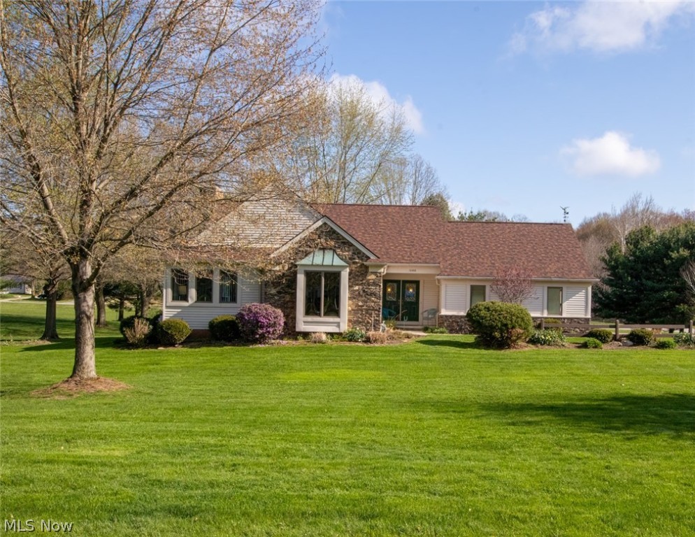 Gorgeous setting! Perfect layout! Exceptional Condition! This solid ranch is perfectly maintained with red oak wood floors throughout the first floor. Natural light & amazing views from every room in the house. Spacious living room has vaulted ceiling with a stunning floor to ceiling river stone fireplace. The living room has access to a finished loft.  Many built ins can be found throughout this home.  The sunroom overlooks the large backyard and has a wall of windows and skylights. The large eat in kitchen has hickory Kraftmaid cabinets, large breakfast bar and walks out to a wood deck.  The third bedroom is being used as an office and does have a closet. The large first floor laundry room is very convenient with access to the garage. The family room in the walkout basement has large windows that bring in lots of natural light. This family room can be used as a playroom, additional office space or the good old-fashioned game room! Pride of ownership is apparent inside and out. Baseme