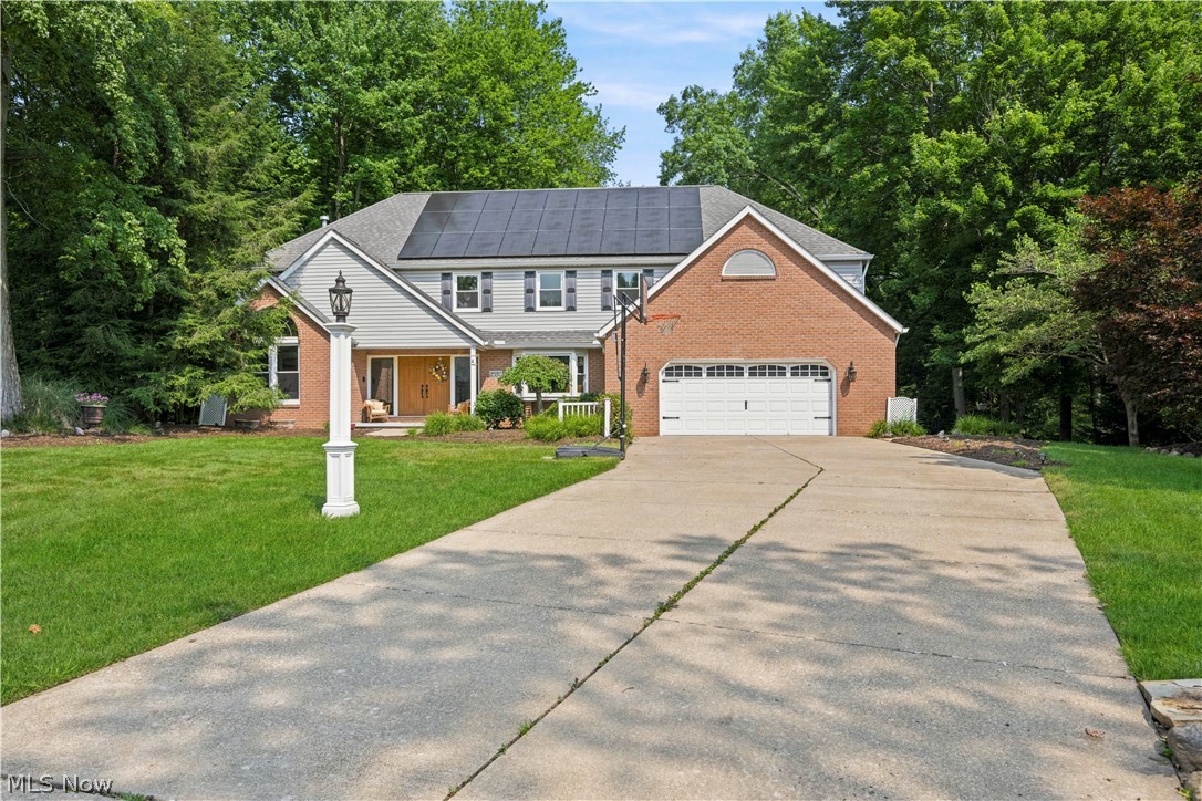 Welcome to this exceptional custom-built 4-bedroom, 3.5-bath home offering over 5,000 square feet of beautifully designed living space. A French door entry opens to a grand two-story foyer with an elegant chandelier and iron baluster staircase. The formal living room features cathedral ceilings, hardwood floors, a Palladian window, built-in cabinetry, and a gas fireplace. The formal dining room showcases custom wainscoting, hardwood flooring, a bay window, and a detailed ceiling. The main level also includes a first-floor bedroom with built-ins, an updated half bath, and a stunning family room with vaulted/beamed ceilings, four skylights, a gas fireplace, wet bar, custom cabinetry, and walls of windows overlooking the private backyard. The chef's kitchen offers granite countertops, stainless steel appliances, soft-close cabinetry, a center island, pantry, coffee bar, breakfast nook, and deck access. French doors lead to a four-season sunroom, currently used as a gym. A well-equipped laundry room completes the first floor.
Upstairs are two spacious bedrooms connected by an open catwalk, an updated full bath, and a luxurious primary suite with hardwood floors, French doors, a 20-foot walk-in closet, and a spa-like ensuite featuring marble finishes, double vanity, whirlpool tub, and glass-enclosed shower. The walkout lower level is ideal for entertaining with a large recreation room, gas fireplace, custom 20-foot bar, full bath, guest bedroom, and access to the covered patio. Outdoor living shines with a three-level deck featuring a hot tub, dining area, built-in benches, fire pit, storage shed, and beautifully landscaped yard. Additional highlights include an attached 2-car garage with EV charger, NEW windows and NEW solar panels for improved efficiency. This one of a kind home offers exceptional craftsmanship, outstanding amenities, and unforgettable indoor and outdoor living. You truly have to experience this home in person to appreciate everything it has to offer!