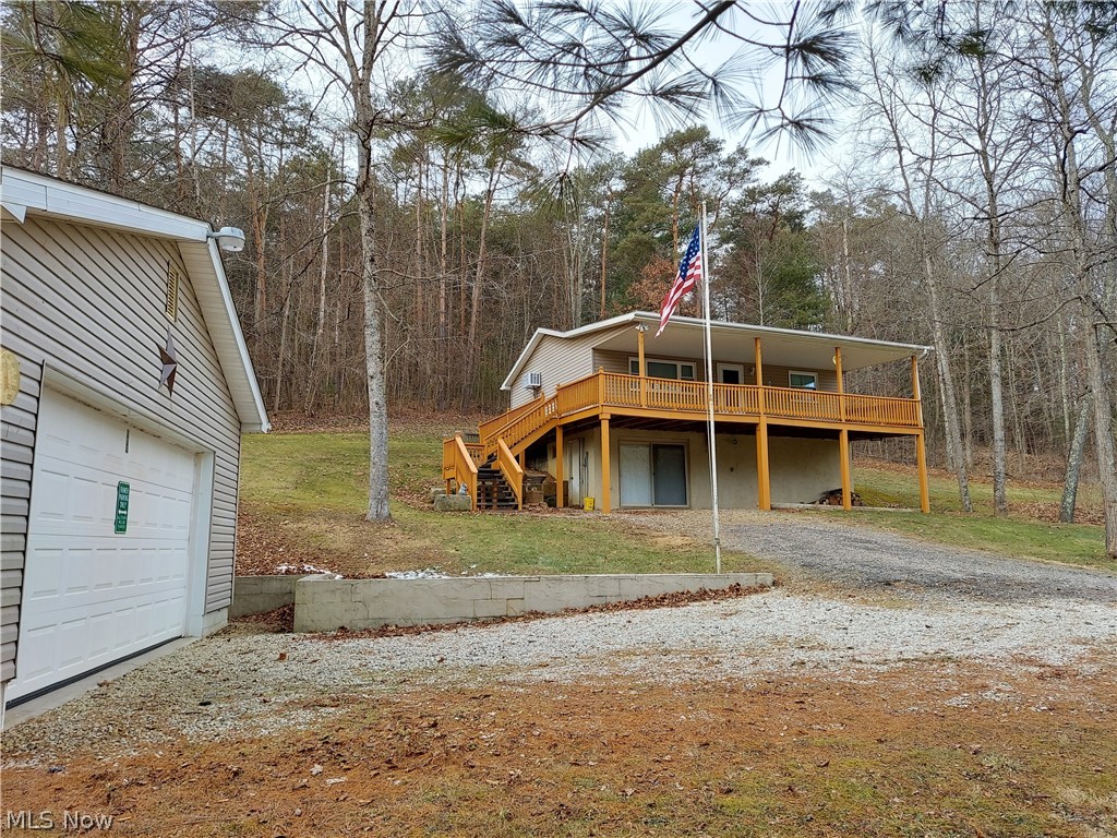 Private country setting only minutes to Salt Fork Lake, this is a fabulous getaway for all your family and friends, with a full walkout basement that could easily be finished and currently has a bedroom and bathroom down so  you can bring extras for the weekend getaway.  An open layout with a breakfast bar and wrap around porch and 2 car detached garage for all your storage needs.   Has a small stream on the property as well and mostly wooded lot for hunting.  14.7 acres with only a couple of acres cleared.  Home has well and septic.   Call today for a tour.