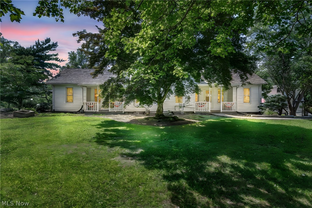 Welcome to this beautifully updated two story home on a sprawling picturesque lot with custom brick walkways, amazing porch and deck space. This rare property features over 3000 sf of living space with a 2 story over sized garage and an outbuilding for additional storage. Entering the home, you will be greeted by a spacious gourmet kitchen, featuring custom tiling, high quality cabinets, huge center island, newer countertops, modern lighting fixtures, and stylish tile backsplash that opens up to the large great room. Adjacent to the kitchen is a large dining room with newer tile flooring. This home also boasts natural woodwork as well as hardwood, and updated laminate flooring. The first level consists of kitchen, dining room, living room, family room, great room, 4 bedrooms and 2 full baths which includes a master suite with a updated bath. First floor laundry conveniently located in the center of the house. The second floor consists of two bedrooms and large bathroom. This home has a gas well and water well on the property. This home also has numerous updates to include newer furnace, central air, hot water tank, light fixtures, electrical, mulch, and more! This home has great potential for an in law suite.