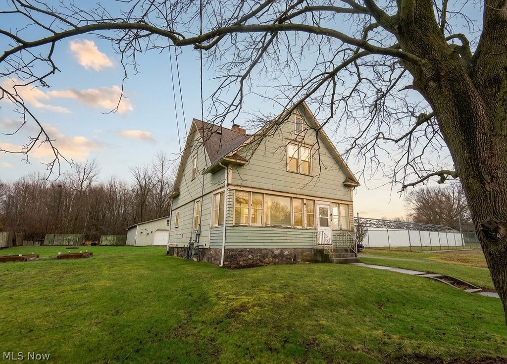 Welcome home to this spacious 3-bedroom, 1.5-bath property located in the West Branch School District. With 10-foot ceilings on both the main floor and second level, this home offers a bright, open feel throughout and showcases 10-inch baseboard trim and beautiful character details.

The dining room features beautiful built-in cabinetry, while the kitchen provides tall cupboards for abundant storage and new flooring. Each bedroom offers massive closet space, and the main bathroom includes a walk-in closet, adding even more functionality and storage.

Enjoy relaxing on the enclosed front porch or entertaining on the back deck overlooking the yard. The property also includes an oversized two-car garage, perfect for vehicles, tools, and additional storage.

Additional updates include an updated boiler system and tankless water heater. Situated on approximately half an acre, this home offers a great blend of space, character, and functionality while still being conveniently located near local amenities.