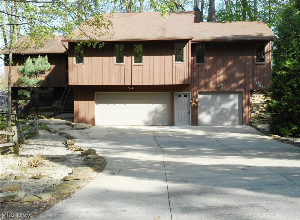 Prime location!  Two Parcels in Merriman Woods on secluded and private cul-de-sac. This spacious, beautiful 4 bedroom, 3 full bath raised ranch offers 3024 SF of living space and many rooms have been freshly painted. The expansive eat-in kitchen offers newer appliances (double ovens), a pantry, ceramic flooring and sliders that open to the deck for easy entertaining. Enjoy the seasons with breath taking views from the dining room, kitchen, living room and family room with more sliders that lead to the huge deck and wooded lot. A gas fireplace accents the family room and is perfect for those cold winter nights. The master bedroom boasts a 7 X 10 walk-in closet and a full bath with an updated, large walk-in shower and double vanity. The guest bath also features double sinks and a skylight that provides lots of natural light. The finished lower level offers a rec room (new carpeting 6/17)  full bath (new flooring 6/17), laundry room (new flooring 6/17) and additional sliders leading to a