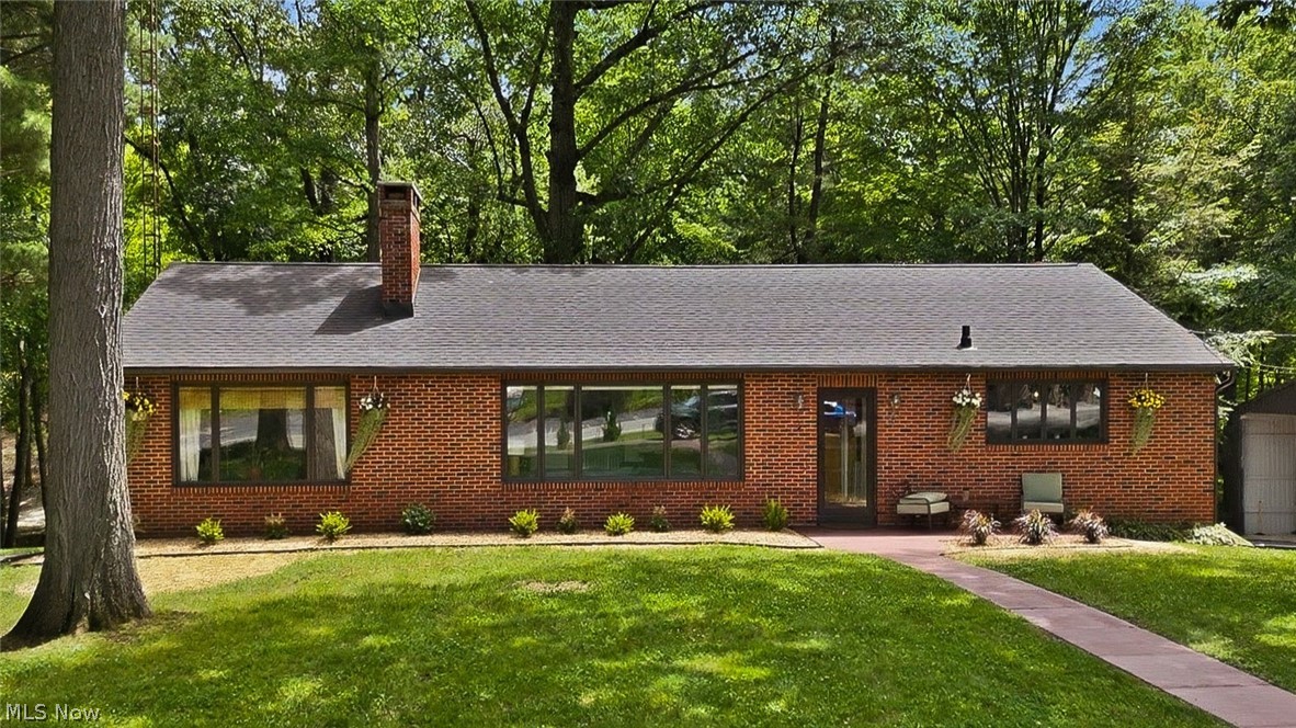 Beautiful four-bedroom, two-bath brick ranch situated on a picturesque 2.25-acre setting with a stream and woods. This move-in ready home features a recently updated kitchen, spacious living areas, and hardwood flooring in three bedrooms. The walkout lower level offers an impressive 700-square-foot great room, providing plenty of space for entertaining, recreation, or relaxing. Additional updates include a furnace and central air system approximately six years old, a whole-house water filtration system, a new roof in 2024, and a new water heater in 2026. A flooring contractor credit is being offered, giving buyers the opportunity to personalize select flooring to their taste. Outside, you'll appreciate the attached garage, circular paved driveway, newly updated front landscaping, a 24x48 pole barn, and an 8x20 shed that could be restored for chickens, hobbies, storage, or outdoor entertaining. Enjoy the privacy and beauty of country living while having plenty of room for projects, animals, and outdoor activities. Priced to sell and being offered as-is, this property presents an outstanding opportunity to own acreage, outbuildings, and a well-maintained home that's ready for its next owner.