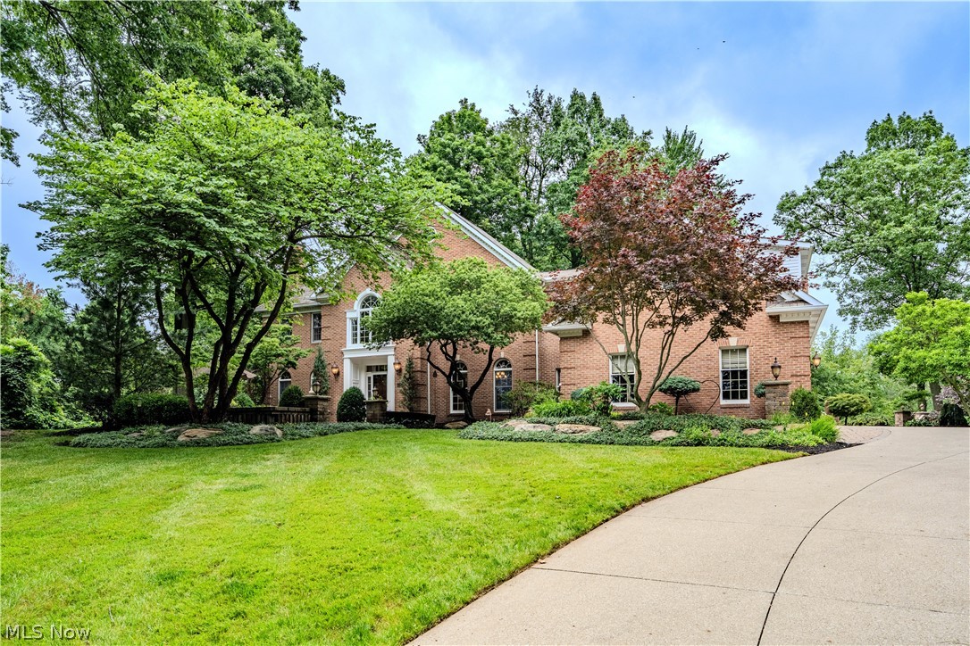 Nestled on 3.19 private acres in the highly desirable Deerfield Woods community, this exceptional custom Colonial offers luxury, privacy, and incredible living space both inside and out. Surrounded by mature trees, professionally landscaped grounds, a koi pond with waterfalls, and many beautiful outdoor gathering areas, this one-of-a-kind property provides a true retreat while remaining close to everyday conveniences.

The grand entry welcomes you into over 6,900 square feet of finished living space, featuring crown molding, custom built-ins, soaring ceilings, and three fireplaces. The expansive kitchen is the heart of the home, offering granite countertops, abundant cabinetry, a large center island, and generous space for entertaining. A four-season room overlooks the scenic backyard and provides seamless access to the outdoor living areas.

Upstairs, the luxurious primary suite features a sitting area, a custom dressing room with built-ins and a granite island, heated tile bathroom flooring, and a beautifully renovated bath with premium finishes. A private suite above the garage offers additional flexibility with its own bedroom, bath, walk-in closet, built-in storage, and living space. The finished walkout lower level is designed for entertaining and recreation, featuring a wet bar, kitchenette, granite countertops, a full bath, surround sound, custom built-ins, and a remarkable 300-gallon aquarium system.

Outdoor amenities include a gazebo, fire pit, expansive patios and walkways, a swim spa area designed for easy entry & exit, and a tranquil koi pond with waterfalls. Residents also enjoy access to Deerfield Woods amenities, including a community pool, tennis courts, a playground, and park areas.

Combining exceptional craftsmanship, extensive updates, and an extraordinary setting, this home offers a rare opportunity in one of Strongsville’s most sought-after neighborhoods.