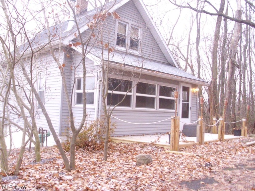 Private living with city amenities.  Three bedroom, two bath bungalow with finished attic.  Last house on a dead end street with a double lot, .67 acres!  The living room features a woodburner that helps reduce the heating costs.  Rustic dining room for entertaining.  First floor bedroom and bath.  The full, walk-out lower level has a full bath and recreation room that has a woodburner, bar and a hot tub.  Roof approximately 6 years old.  The enclosed front porch can be used most of the year.  Siding and windows approximately 9 years old.  The large back yard is completely fenced in for family fun or pets.  This home has a new deck on the front and side deck for entertaining.  Move-in ready, a must see.
