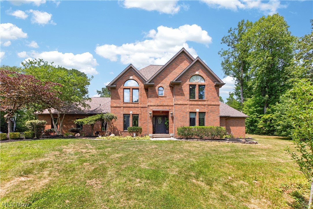 Nestled on a beautifully landscaped 1.74-acre cul-de-sac lot in desirable Chesterland, this brick Transitional Colonial offers timeless style, thoughtful updates, and exceptional privacy. Set back from the road and surrounded by mature trees, the property provides a peaceful setting while remaining close to everyday conveniences. Inside, a spacious floor plan features a dramatic step-down great room with soaring ceilings, a fireplace, custom built-in cabinetry, and beautiful backyard views. The eat-in kitchen is the heart of the home with freshly painted cabinetry (2026), new flooring (2026), a bayed dining area, and adjoining workspace. Granite flooring throughout the main level (2021), formal living and dining rooms, a private first-floor den/office, first-floor laundry with new cabinetry (2023), and two half baths complete the main level. The first-floor primary suite includes a private bath and walk-in closet updated in 2022. Upstairs are three generously sized bedrooms, including one with an updated ensuite bath (2020), a renovated hall bath (2022), hardwood flooring throughout (2022), and a versatile loft ideal as a media room, playroom, or additional living space. Relax or entertain on the expansive rear deck overlooking the private wooded backyard. The 1.74-acre property also features a storage shed, invisible pet fence, and plenty of space to enjoy the outdoors. Additional updates include a new well pump (2025), hot water tank (2026), well pressure tank (2019), leaf gutter guards (2021), generator line, and an attached three-car garage. Combining space, quality, and a highly desirable cul-de-sac location, this is a wonderful opportunity to call Chesterland home.