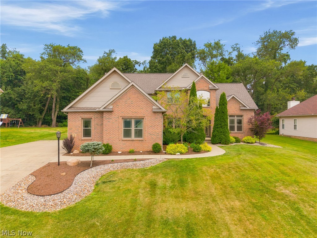Located on a quiet cul-de-sac in St. Ives, this lovely home offers nearly 2,800 square feet, 4-5 bedrooms, 3 full baths, a 3 car garage and a beautiful .37-acre lot with a wooded backdrop that gives you plenty of privacy to enjoy the outdoors. The two-story foyer makes a striking first impression and opens to a vaulted great room with a floor-to-ceiling stone fireplace that's ready for everything from cozy evenings to holiday gatherings. The spacious kitchen has been updated with new cabinetry and solid surface countertops. French doors off the dinette lead to a stone patio complete with a fire pit, an easy favorite spot to relax or gather with friends. The formal dining room features a board and batten accent wall, and the first-floor laundry is conveniently located just off the kitchen. A first-floor bedroom next to a full bath gives you flexibility for guests, a home office, or multi-generational living. Upstairs, you'll find four additional bedrooms, including the owner's suite with two sinks, soaker tub, and separate shower and commode. The list of updates is impressive, including custom double-hung triple-pane windows with transferable warranty replaced within the last two years (all except the window above the front door), new flooring throughout the first floor, stairs, and upstairs hallway, a custom front door, solid core interior doors, updated lighting, switches and outlets, two new sump pumps and new hot water tank installed within the last year, fresh landscaping with hardwired landscape lighting, and the front portion of the roof replaced in 2024. Basement waterproofing was done by the previous owner. Located in Lake Township and served by North Canton Schools, this home also includes a CINCH Home Warranty for the new owner. ALL inspections have recently been completed by the seller and can be made available for your review. Plan to view this beautiful home soon!